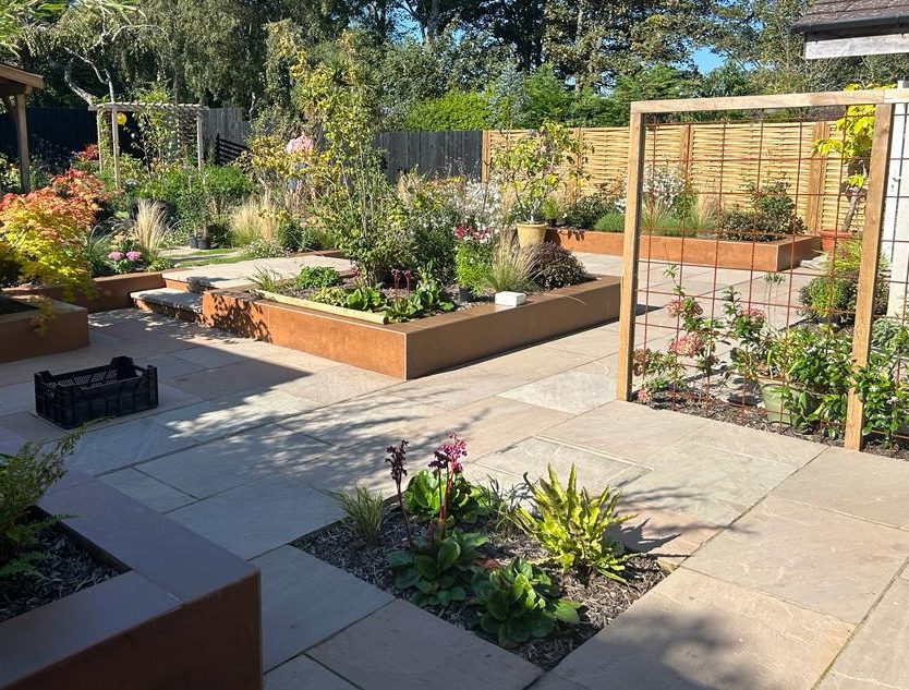 Sandstone terrace with corten steel raised beds